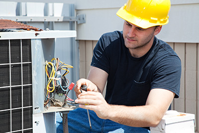 Professional performing air conditioner repair in Mantoloking
