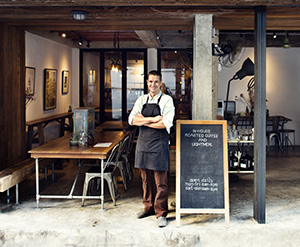 Business owner standing outside their cafe after partnering with Toms River SEO professional