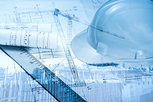 Blue-hued picture with a hard hat, ruler, and blueprints; all tools of the trade for home builder in New Jersey
