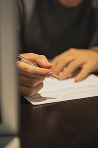 Homeowner writing down terms related to air conditioner repair in Mantoloking
