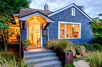 Seaside Park rentals exteriors matter; blue illuminated home with beach decor