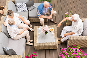People sitting on a custom project by deck contractor in Surf City
