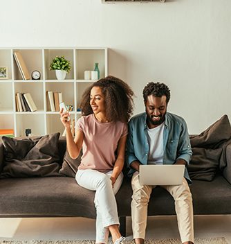 Couple relaxing on their couch after air conditioner repair in Mantoloking